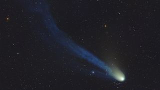 Devil Comet 12P/Pons-Brooks appears as a bright white and green comet with a long blue tail with a distinct kink in it. 