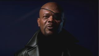 Samuel L. Jackson wears his iconic eye patch while talking in front of a window in Iron Man.