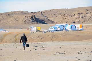 John Schutt walks to the Haughton-Mars Project (HMP) base on Devon Island.
