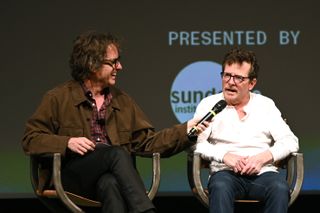 (L to R) Director and producer Davis Guggenheim and Michael J. Fox speak onstage during a Q&A following the world premiere of Apple Original Films' “STILL: A Michael J. Fox Movie” at the Eccles Center at Sundance Film Festival 2023. “STILL: A Michael J. Fox Movie” is coming soon to Apple TV+ in 2023.