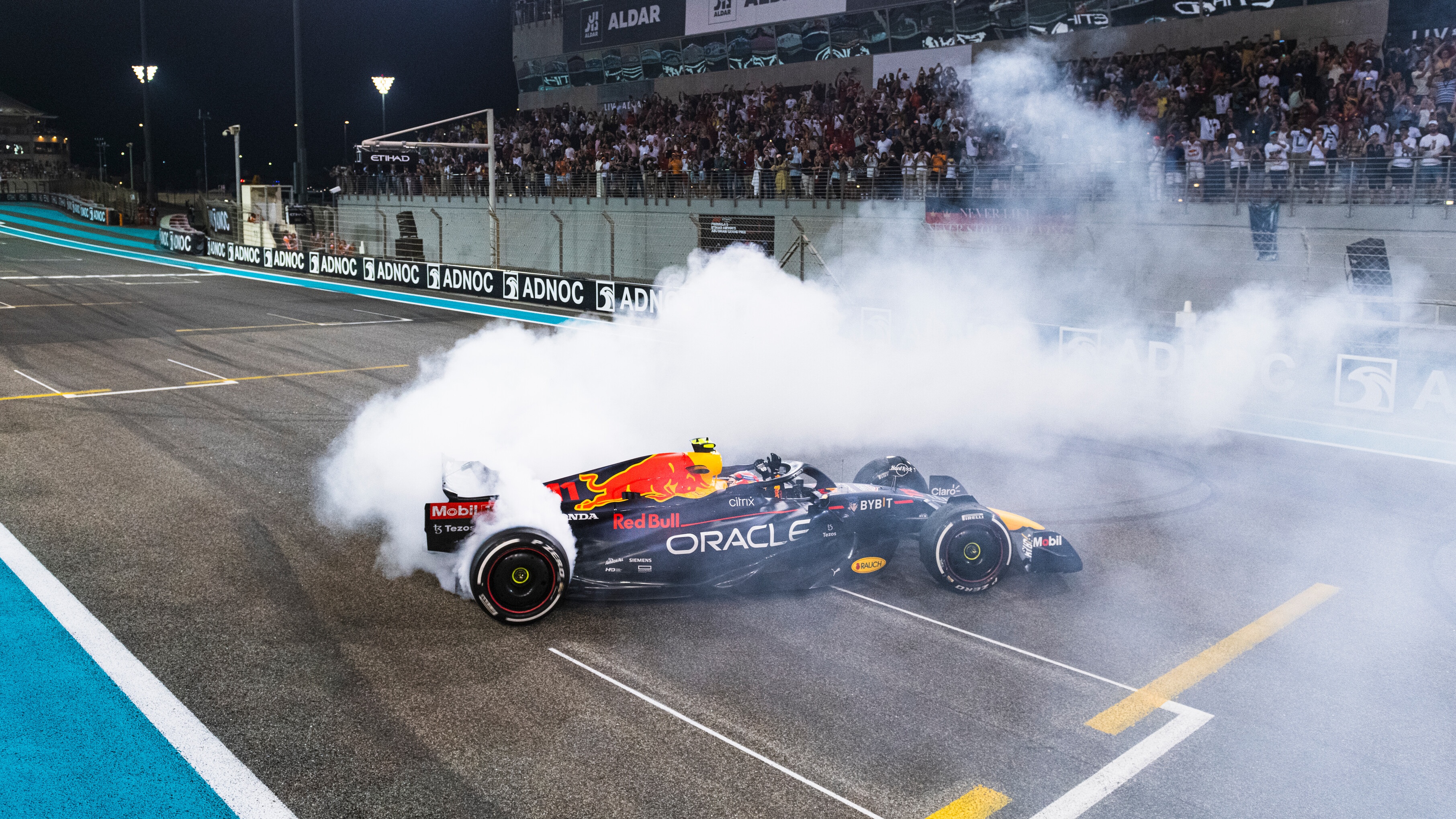 Red Bull F1 car doing doughnuts on the track