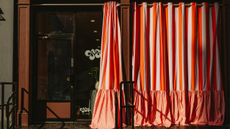 a storefront with large striped curtains
