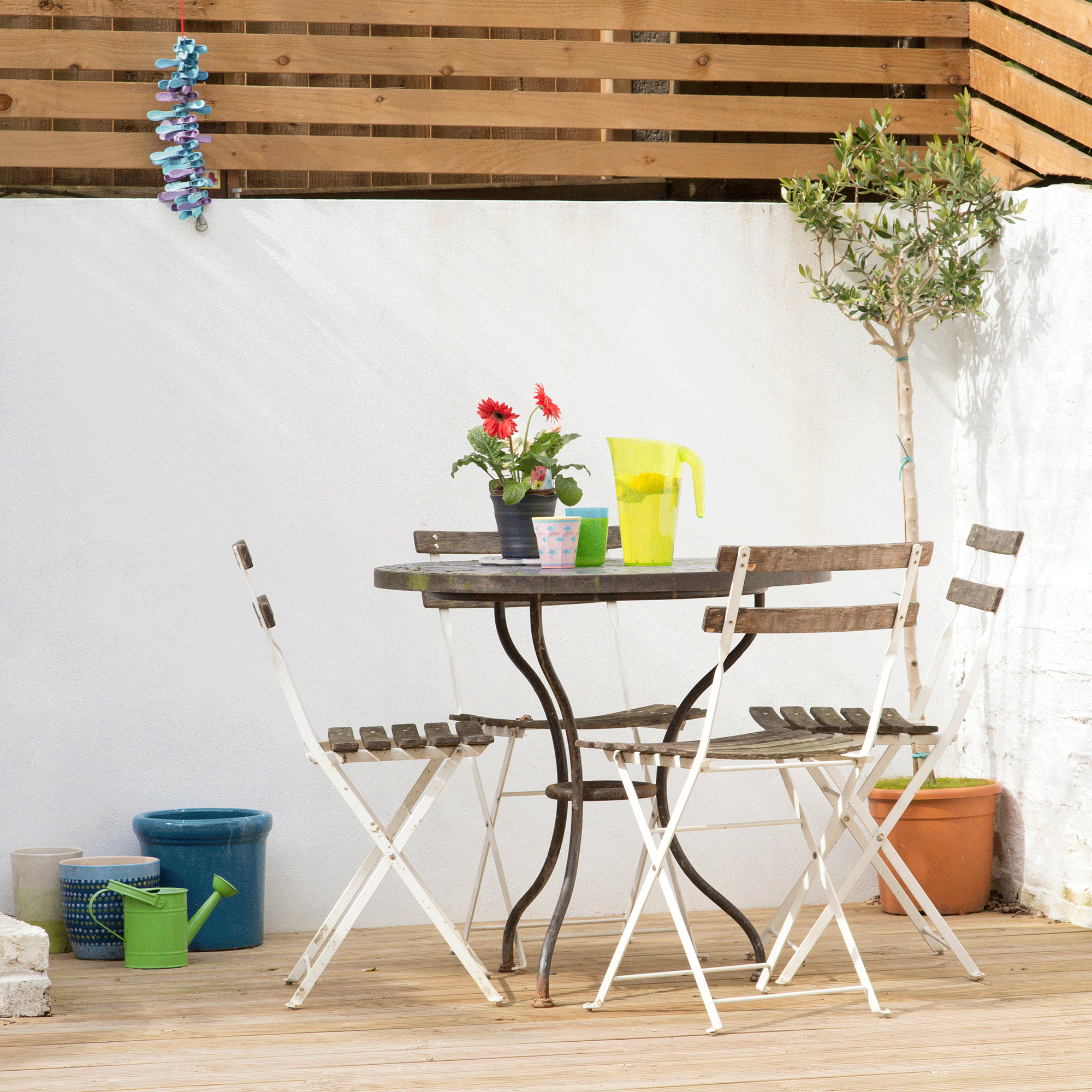 White rendered wall with bistro set