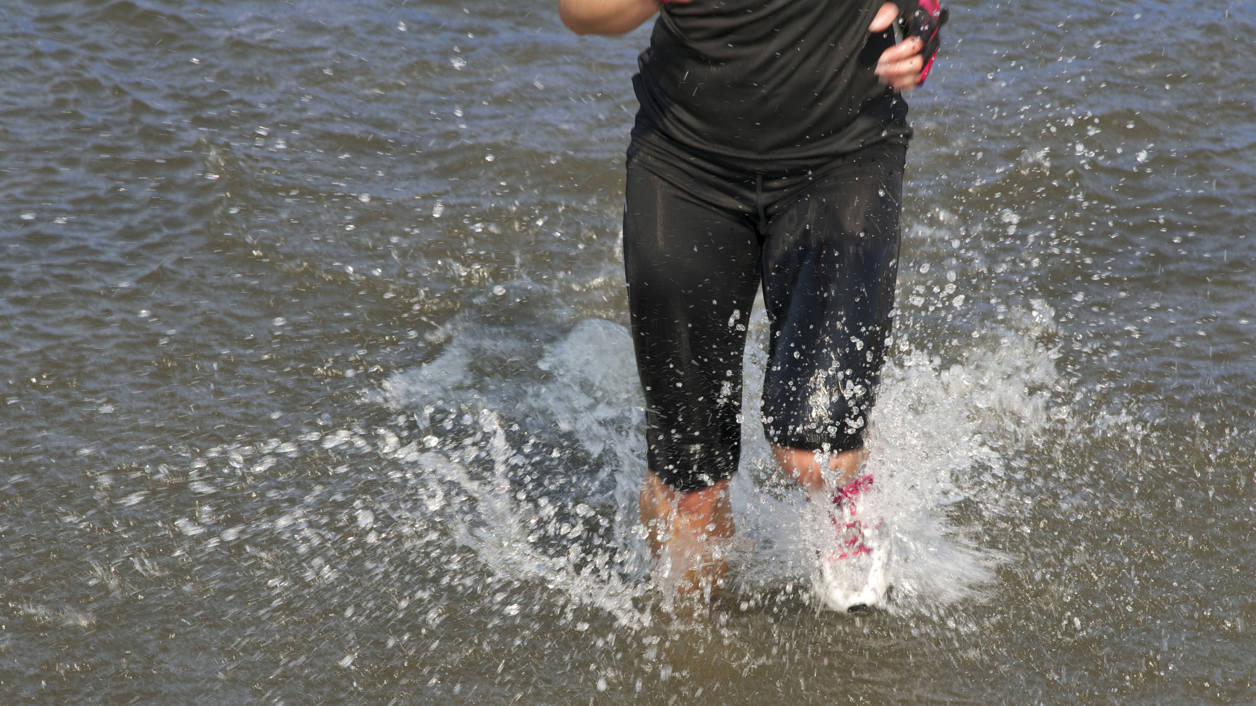 Person running in outdoor water