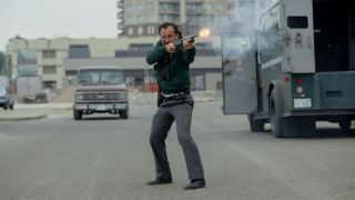 Jude Law firing a shotgun in The Order