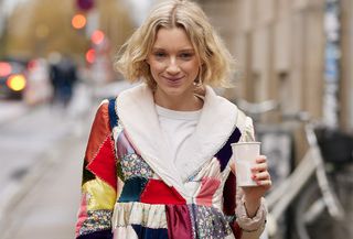 quilted patchwork jacket trend shown on a woman walking down the street