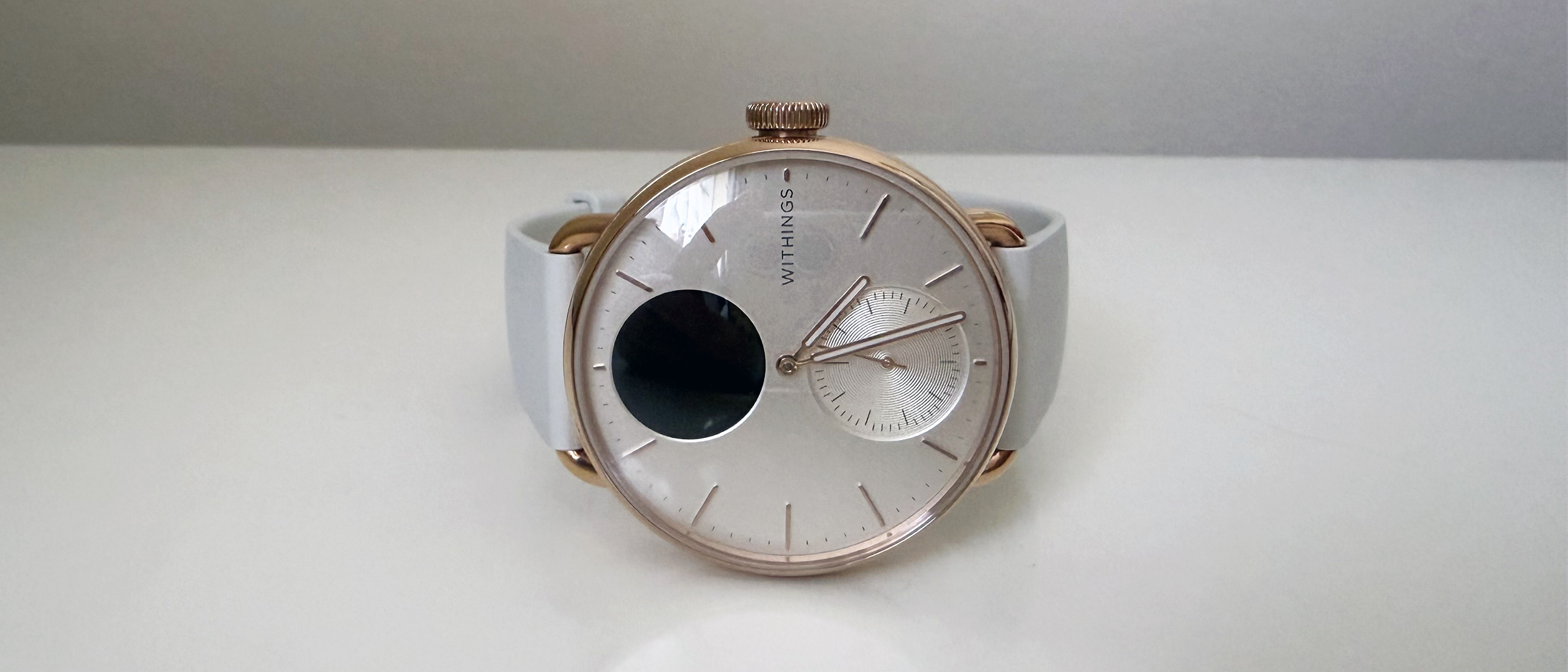 The WithingsScanWatch 2 on a table against a white wall