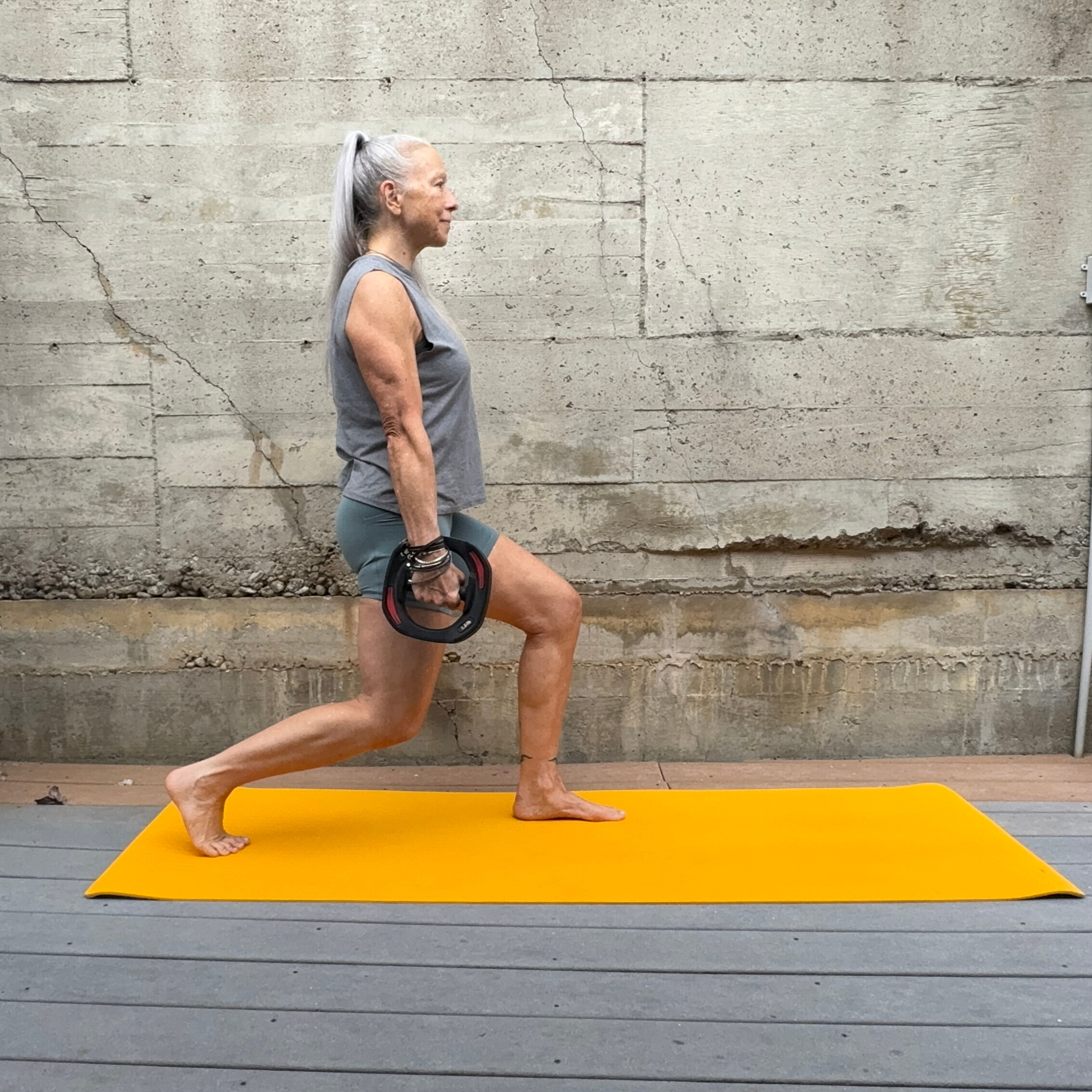 Woman exercising with weight plate