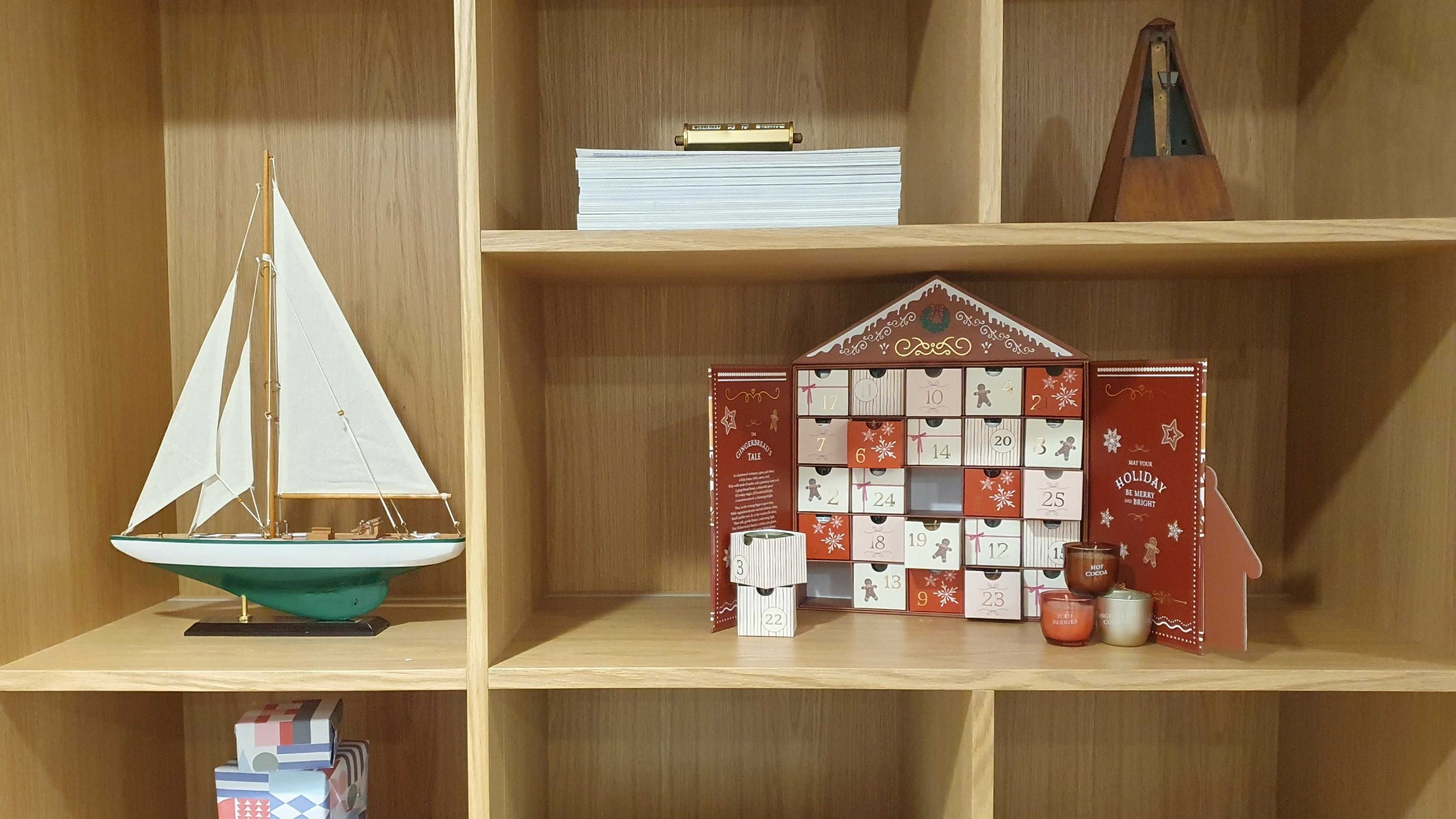 The Aldi scented candle advent calendar open on a styled bookshelf