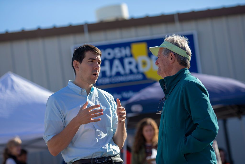 Josh Harder speaks with a supporter.