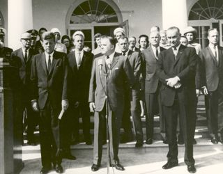 NASA Administrator James E. Webb (center) cites the space achievements of the Project Mercury Astronauts who received the 1963 Collier Trophy Award in a ceremony held at the White House on October 10, 1963. President John F. Kennedy (left) and Vice Presid