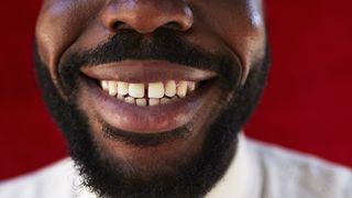 a close-up of a smiling man's mouth