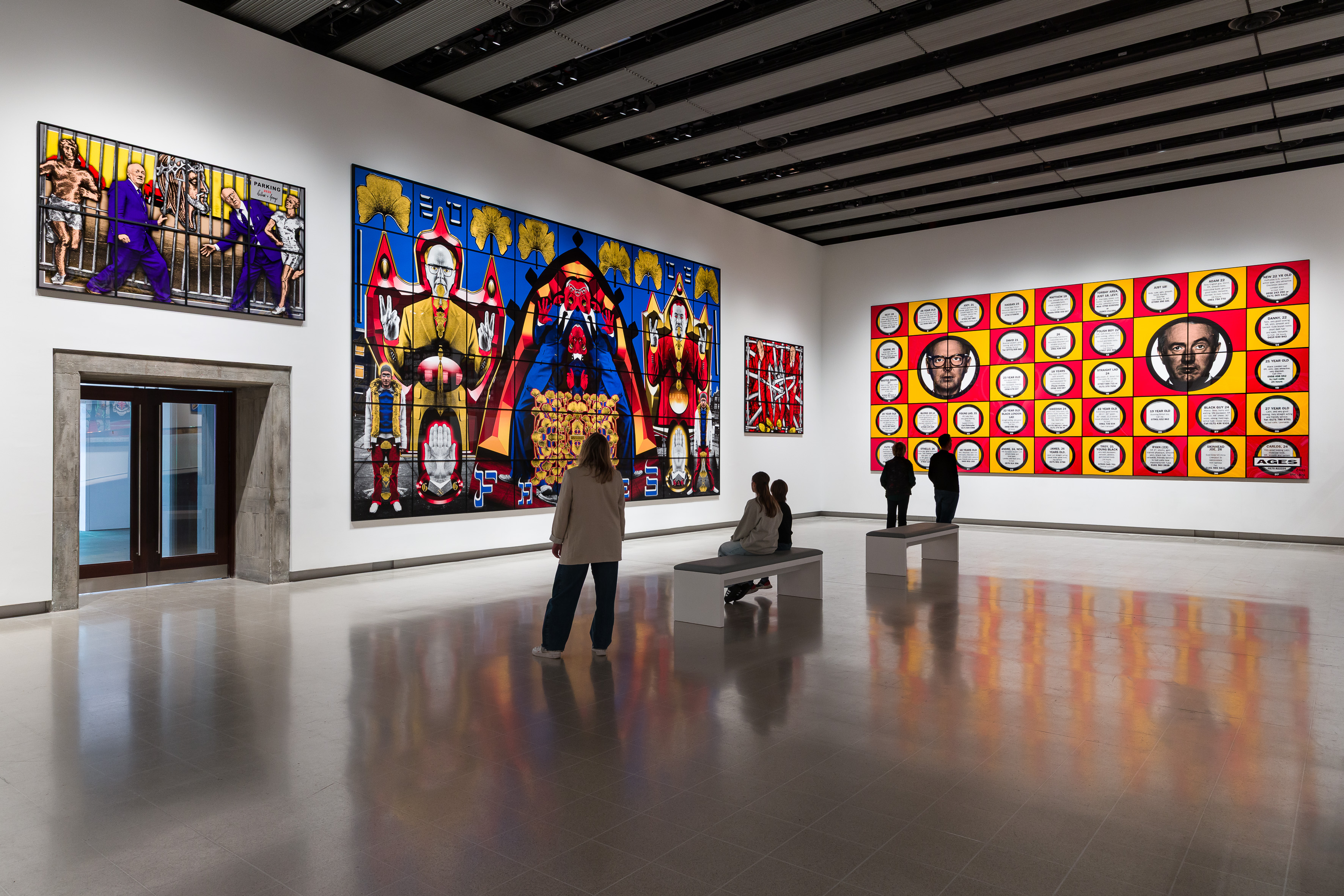 People stand in a gallery and look at art