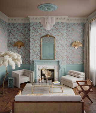 pale blue and blush living room with crane wallpaper, art deco accessories, gold and glass coffee tables, upholstered armchairs, wooden chair, fan wall lights, parquet flooring