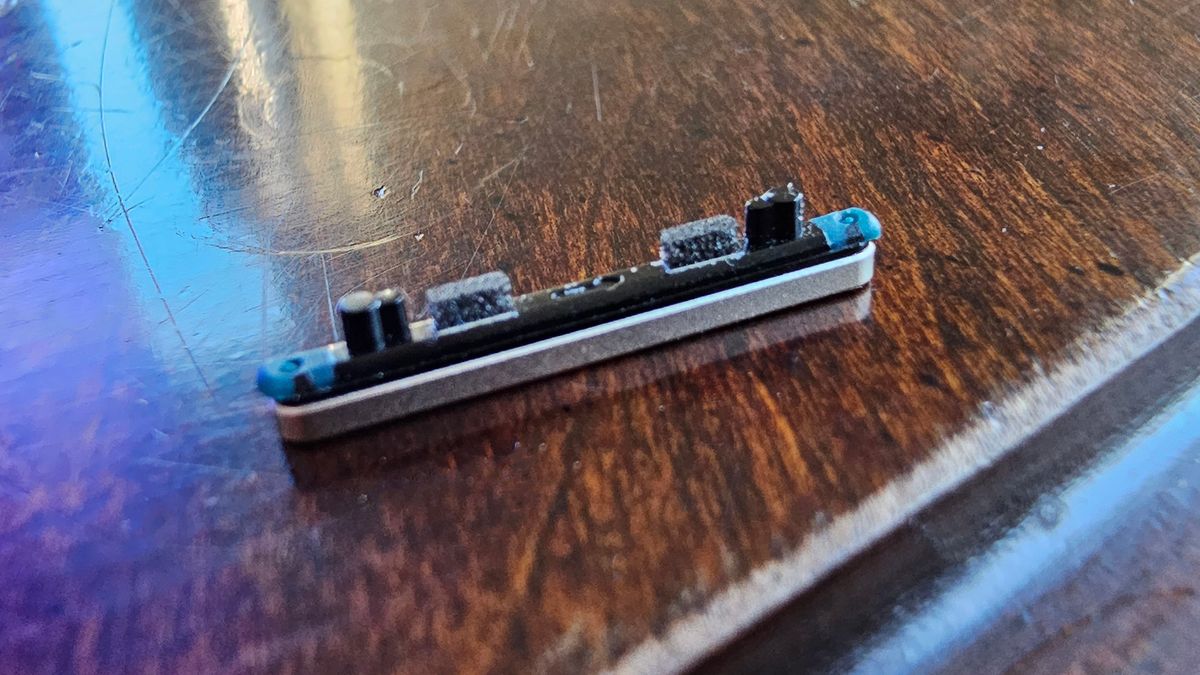 The detached volume rocker from a Google Pixel 7 Pro