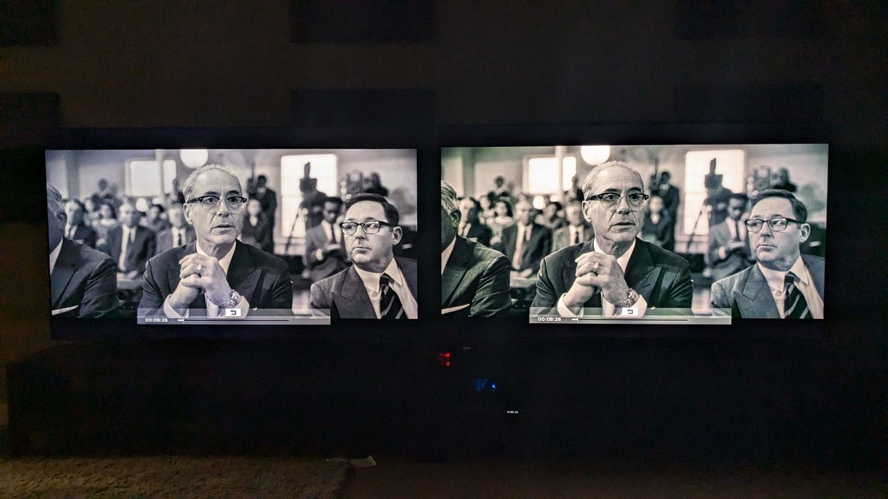 Samsung QN85D and Hisense U7N with Oppenheimer black and white scene on screen in dark room
