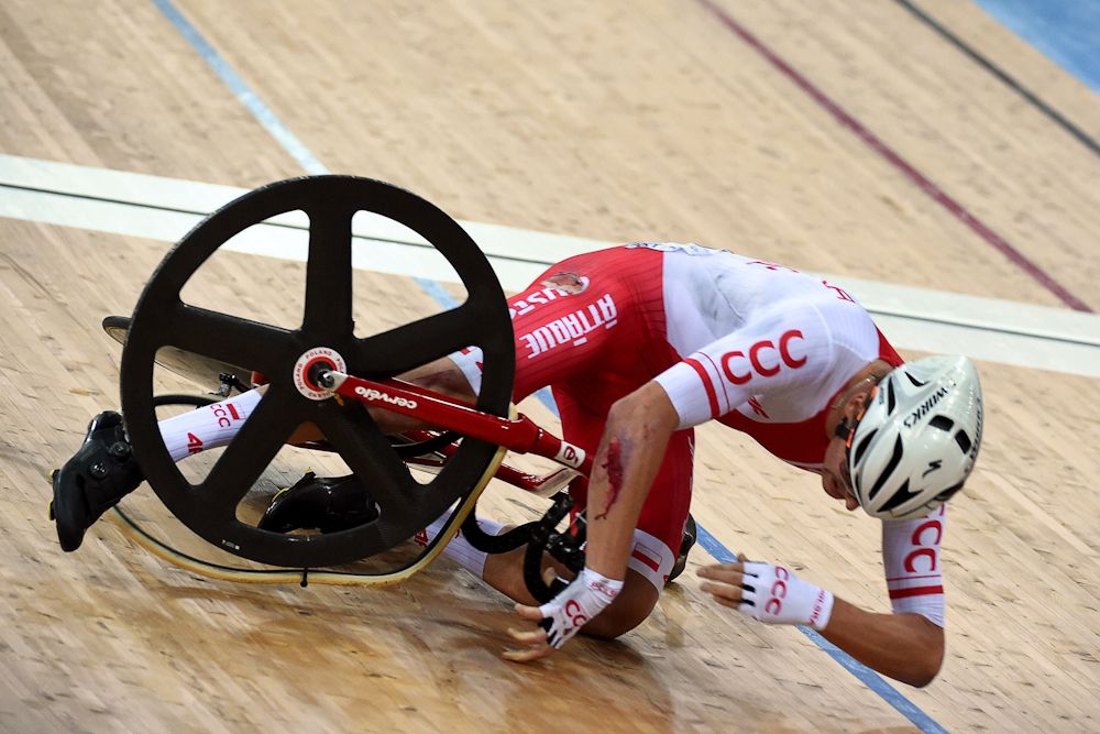 Poland's Szymon Sajnok lies on the track after crashing during the men's omnium elimination race 3/4 at the Hong Kong Velodrome