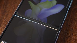 A Samsung Galaxy Z Flip 4 with a display that broke at the hinge