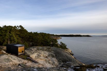 Swedish sauna perched ob rock seaside outdrop