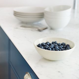 white marble worktop and white bowl with fruits