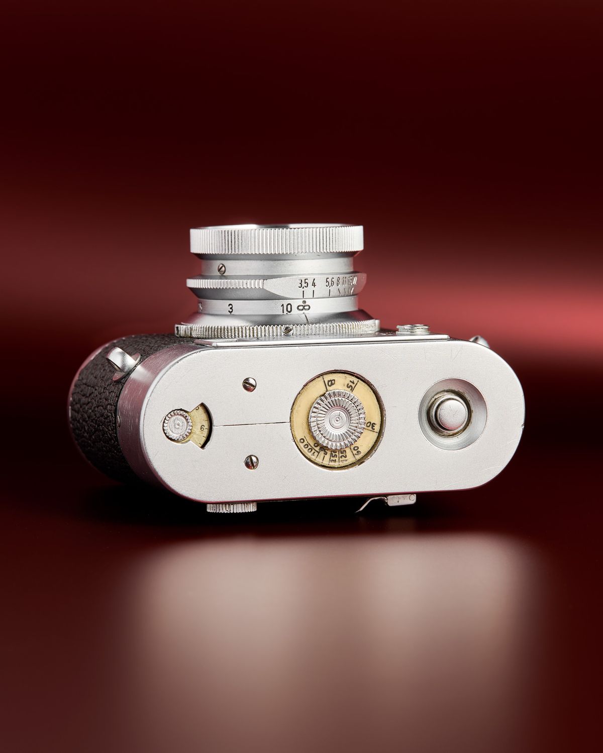 The working Leica Box camera prototype from the mid 1950s on a red background