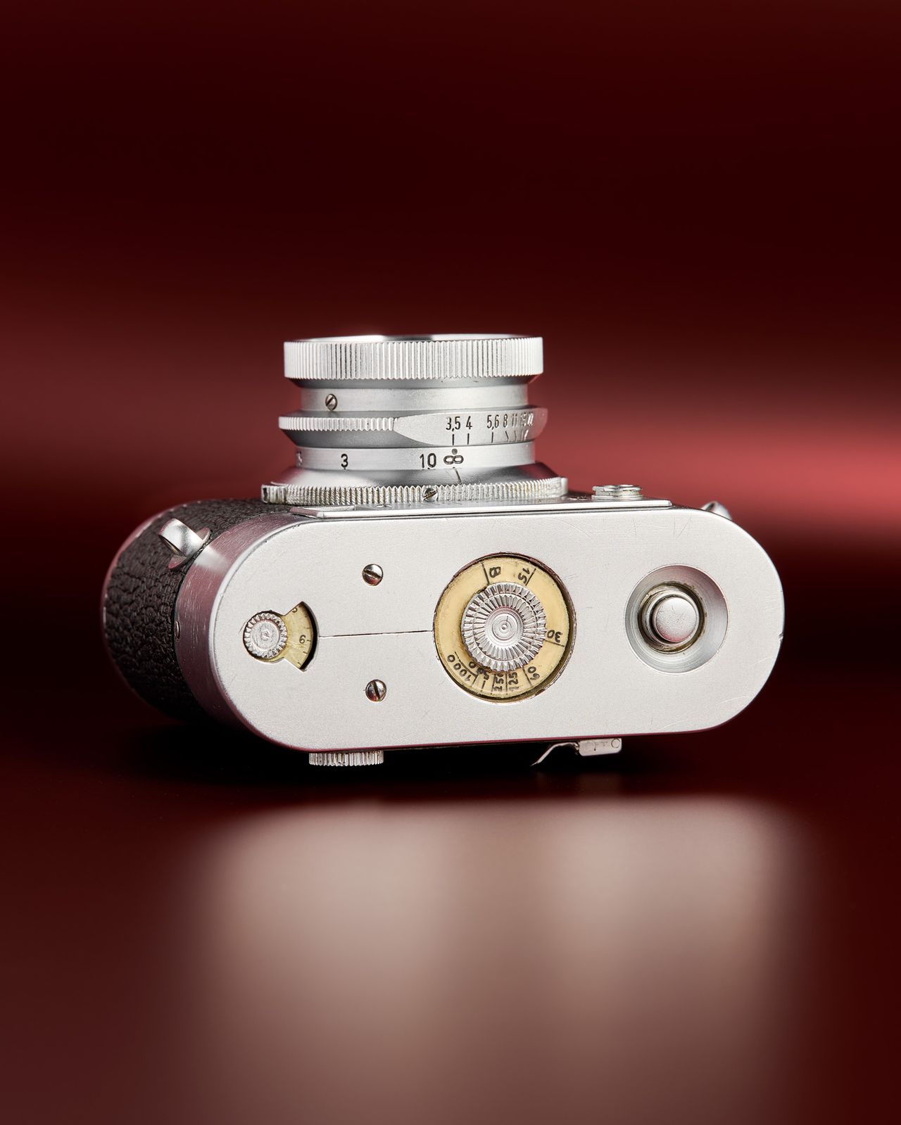 The working Leica Box camera prototype from the mid 1950s on a red background