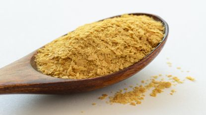 Wooden spoon of nutritional yeast