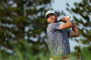 Sam Burns watches his tee shot after hitting a driver