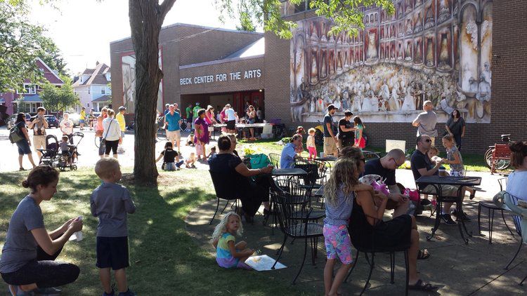 A group of families gather outside a performing arts center using Listen Technologies solutions for assistive listening. 