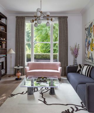 living room with pink sofa and large window