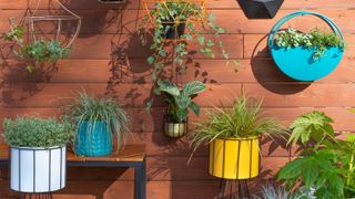 a small patio with wall planters and pots - Pic credit Dunelm