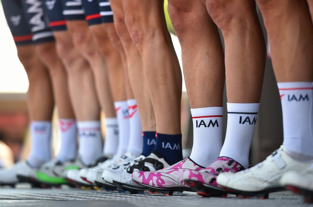 A pair of blue socks stands out against the white as IAM Cycling are presented to the crowd