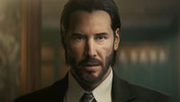 John Wick stares into the camera while wearing a suit