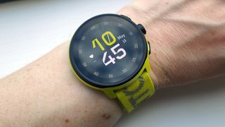 Wrist wearing yellow Suunto Run