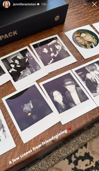 A wooden table covered in polaroid photos of Jennifer Aniston, Courteney Cox and friends