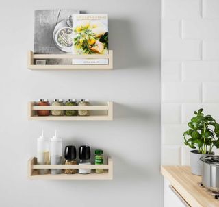 Grey kitchen wall with IKEA spice racks on the wall to show how to organise a kitchen on a budget