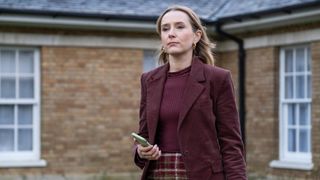 Alison holds her phone in Code of Silence