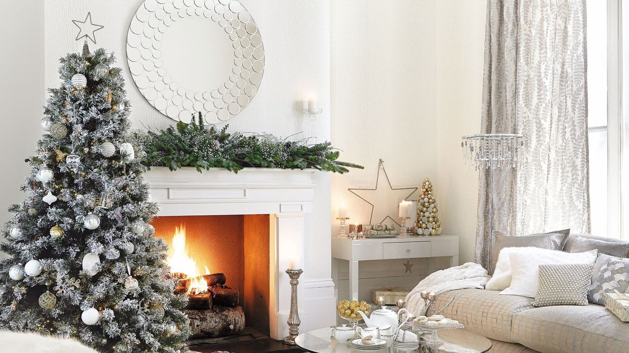 Frosted Christmas tree decorated with baubles inside white and grey living room