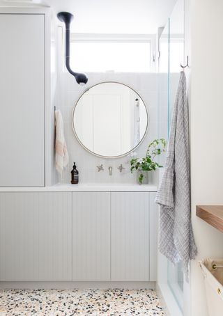 A small bathroom with light fixture