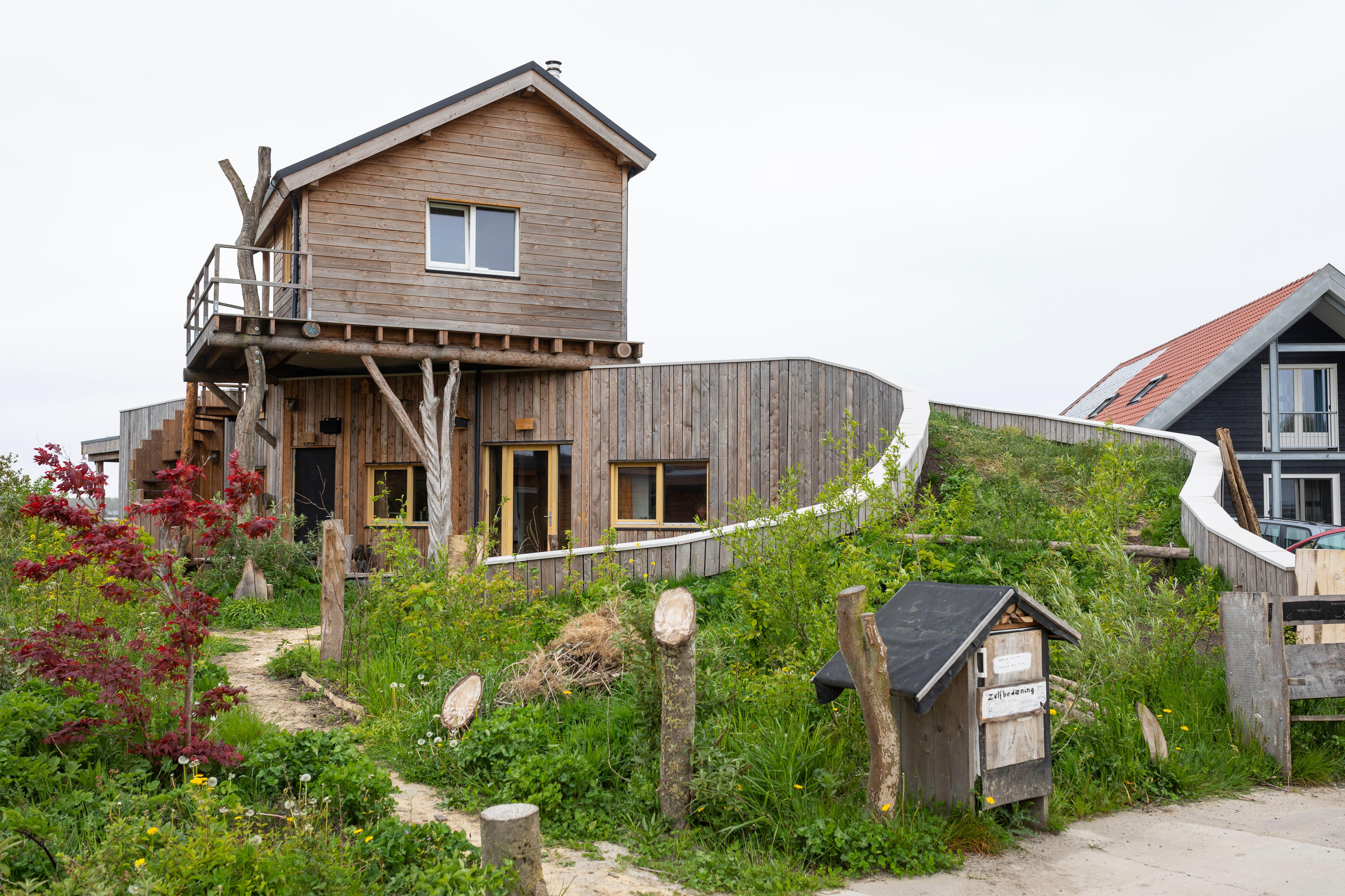 Eco friendly house at eco village Oosterwold, Almere in the Netherlands. It is timberclad, and seems to be sinking into the landscape