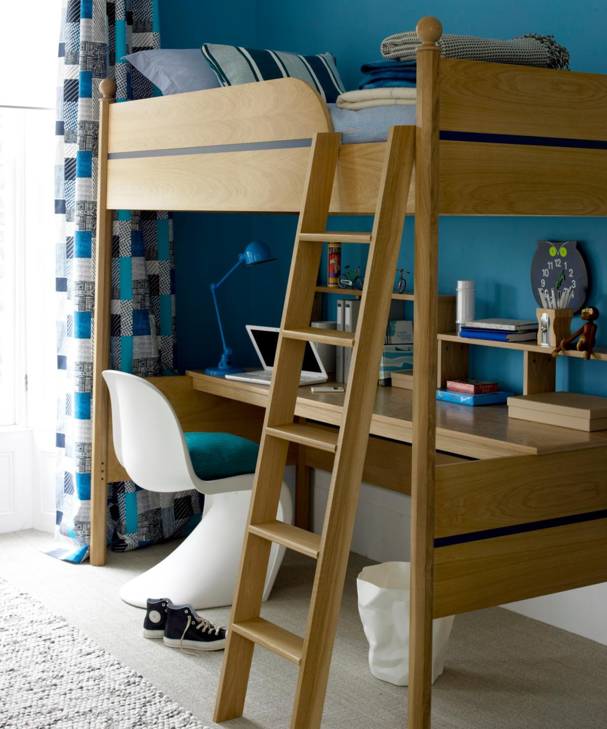 a bunk bed in a blue painted room