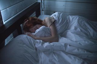 Woman in bed in half-light