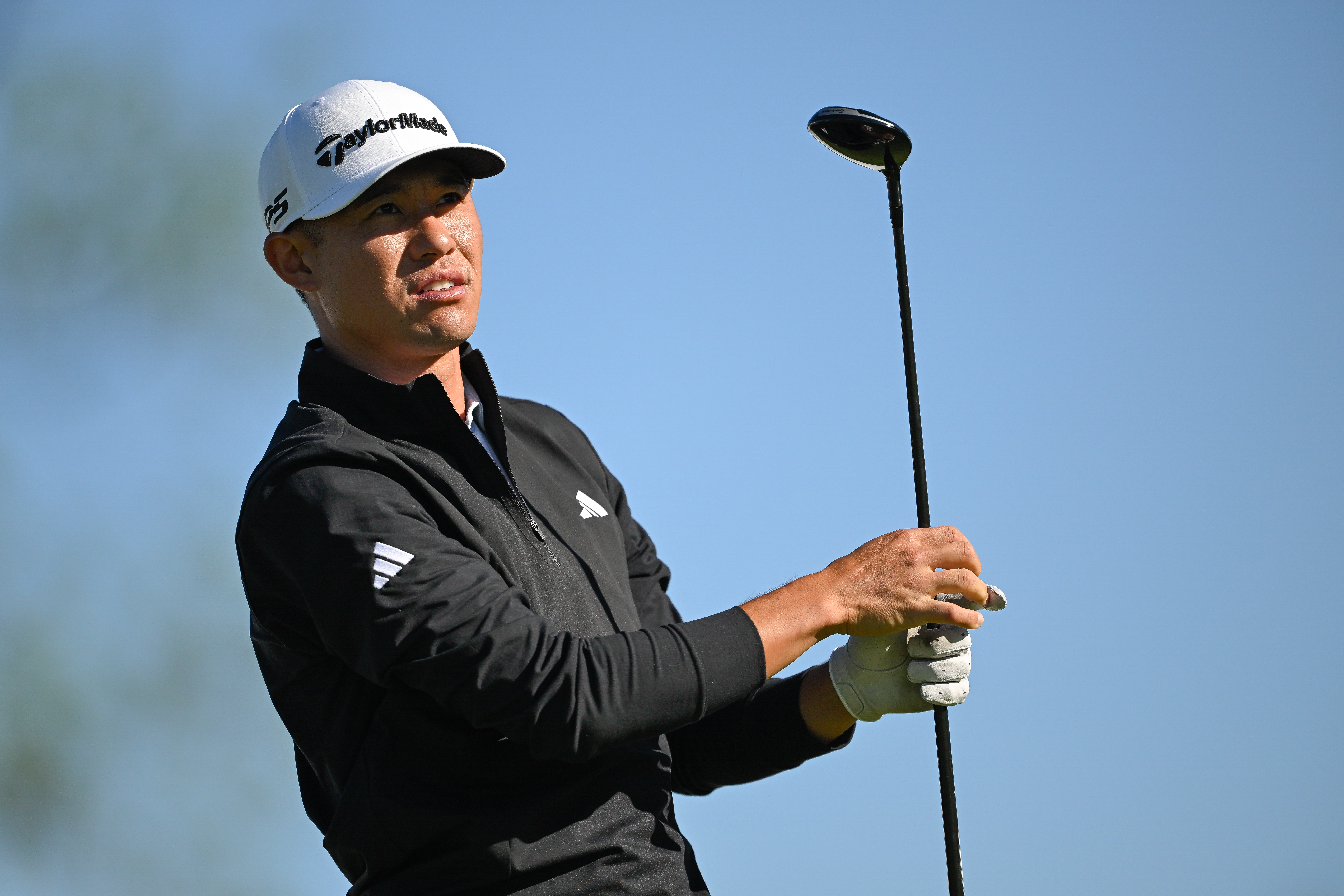 Collin Morikawa strikes a fairway wood