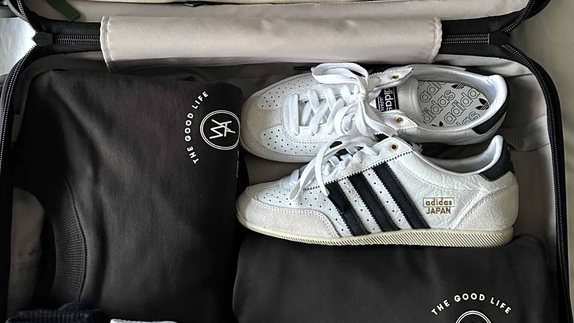 Adidas Japan trainers packed in a suitcase.