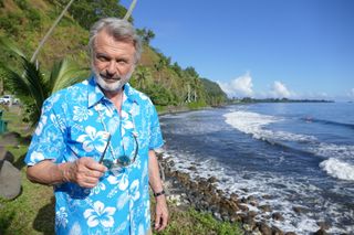 Sam Neill on a rocky beach