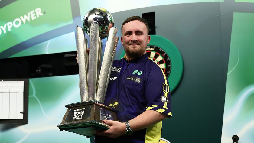 Luke Littler holding the Sid Waddell Trophy after winning the World Darts Championship at Alexandra Palace in January 2025
