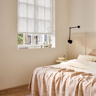 Neutral bedroom with roller blinds in the window