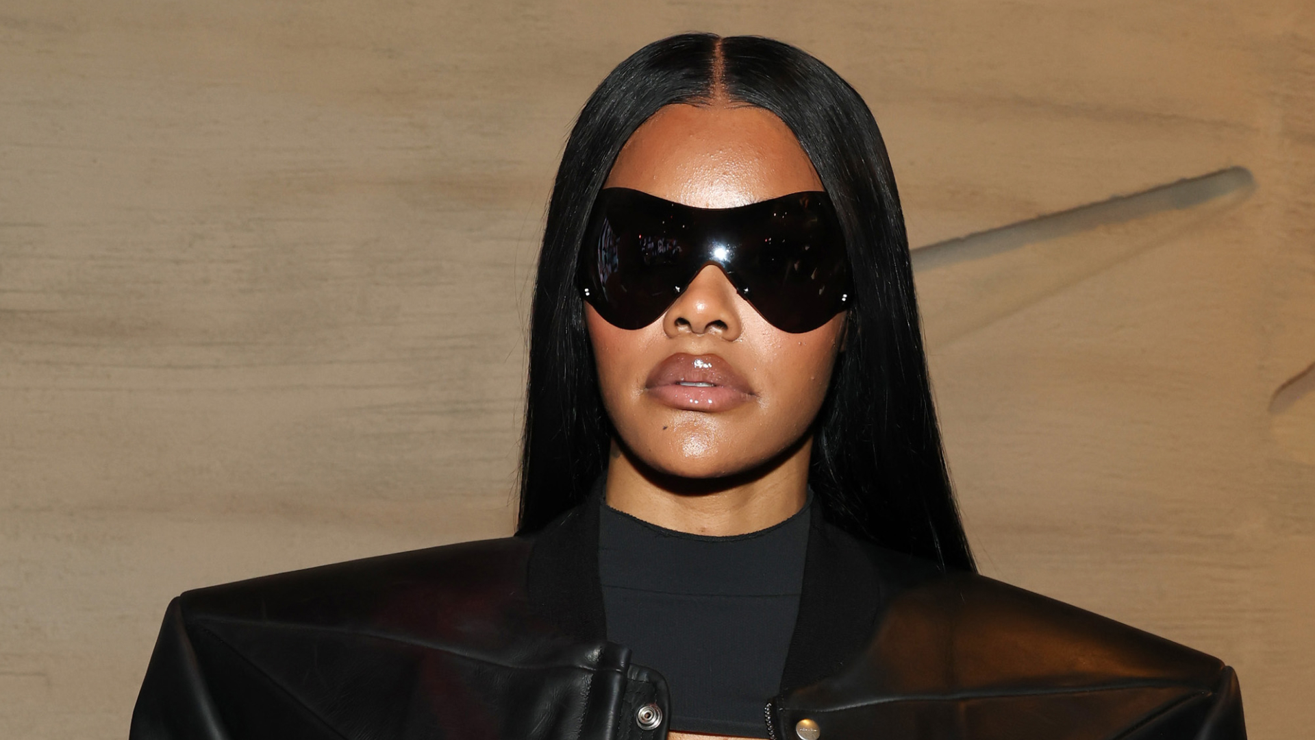 Teyana Taylor wearing black sunglasses a long black hair 