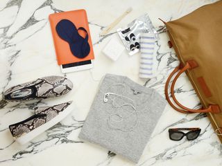 A travel bag - including snakeskin trainers and cashmere jumper
