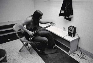 David Gilmour tuning his guitar backstage